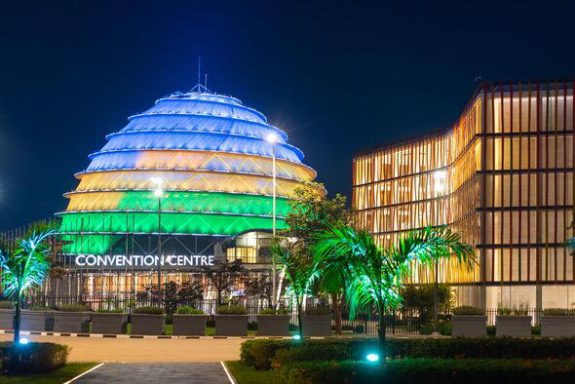 Kigali Convention Centre at night, lit up in the colors of the Rwandan flag